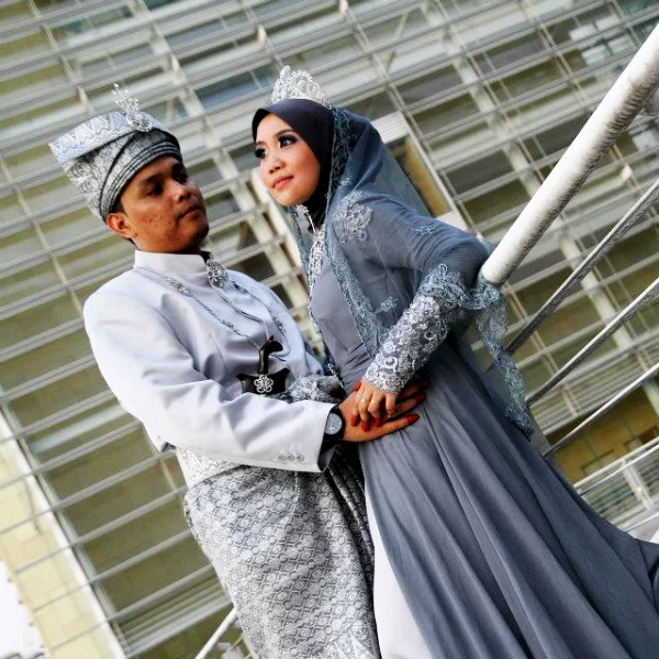 bride and groom under a hand bridge